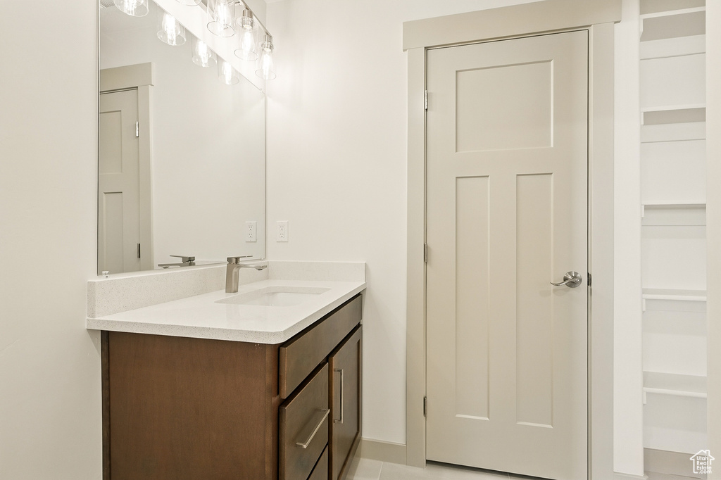 Bathroom featuring vanity, built in shelves, and baseboards