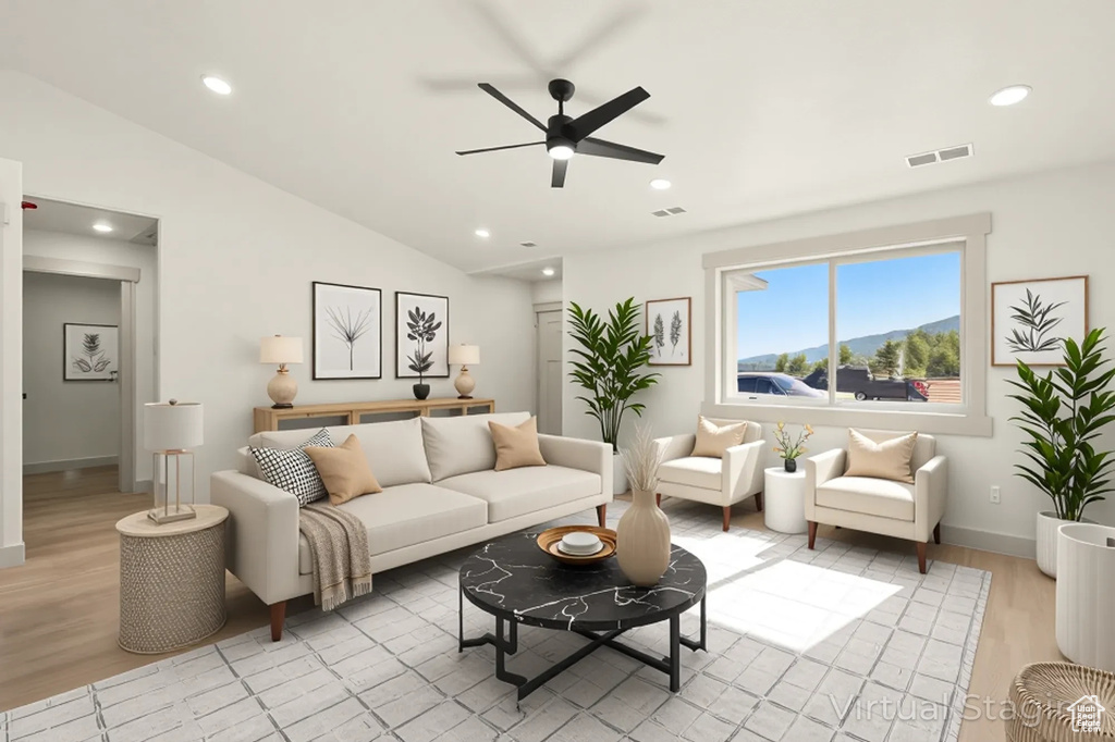 Living area with ceiling fan, light wood-type flooring, recessed lighting, baseboards, and lofted ceiling
