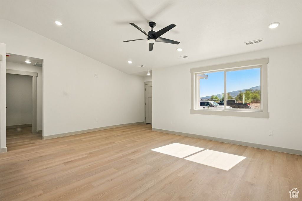 Spare room featuring light wood finished floors, baseboards, a ceiling fan, and recessed lighting