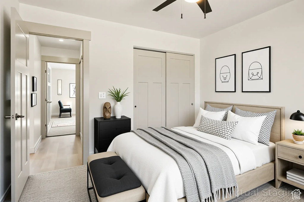Bedroom with a closet, light wood finished floors, ceiling fan, and baseboards