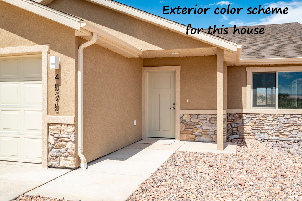 Entrance to property with roof with shingles, an attached garage, stone siding, and stucco siding