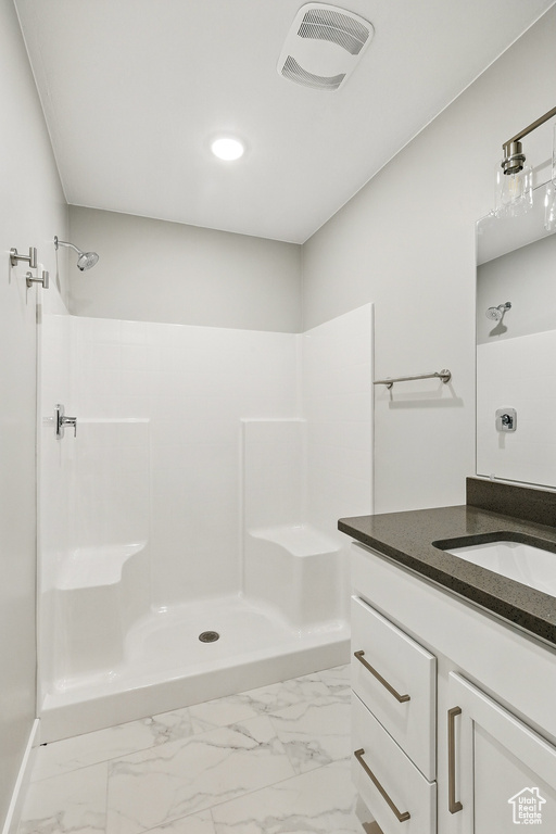 Full bath with visible vents, a walk in shower, vanity, marble finish floor, and recessed lighting