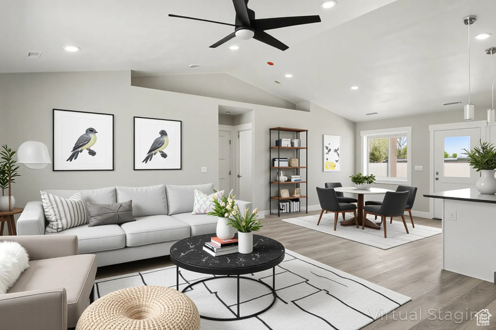 Living area with baseboards, light wood-type flooring, recessed lighting, a ceiling fan, and vaulted ceiling