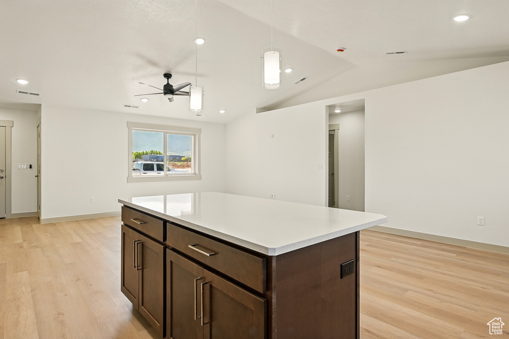 Kitchen featuring light wood-type flooring, ceiling fan, dark brown cabinetry, recessed lighting, and light countertops