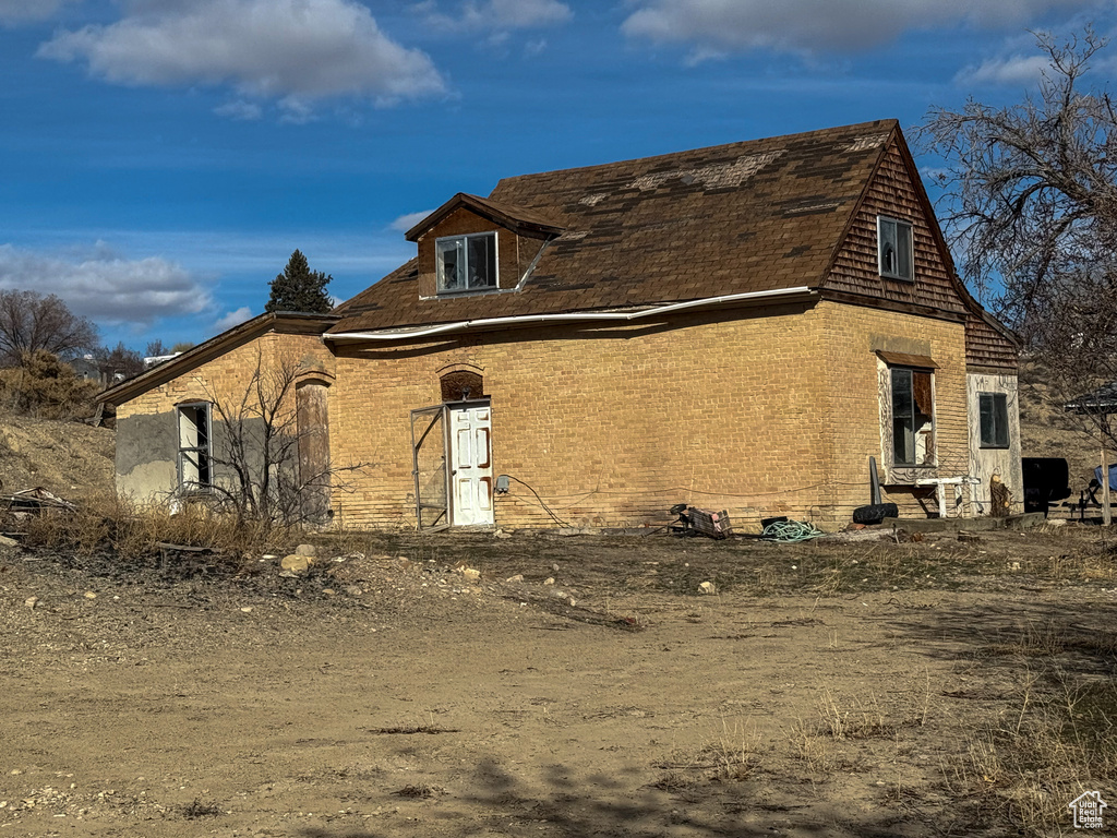 View of side of home featuring brick siding