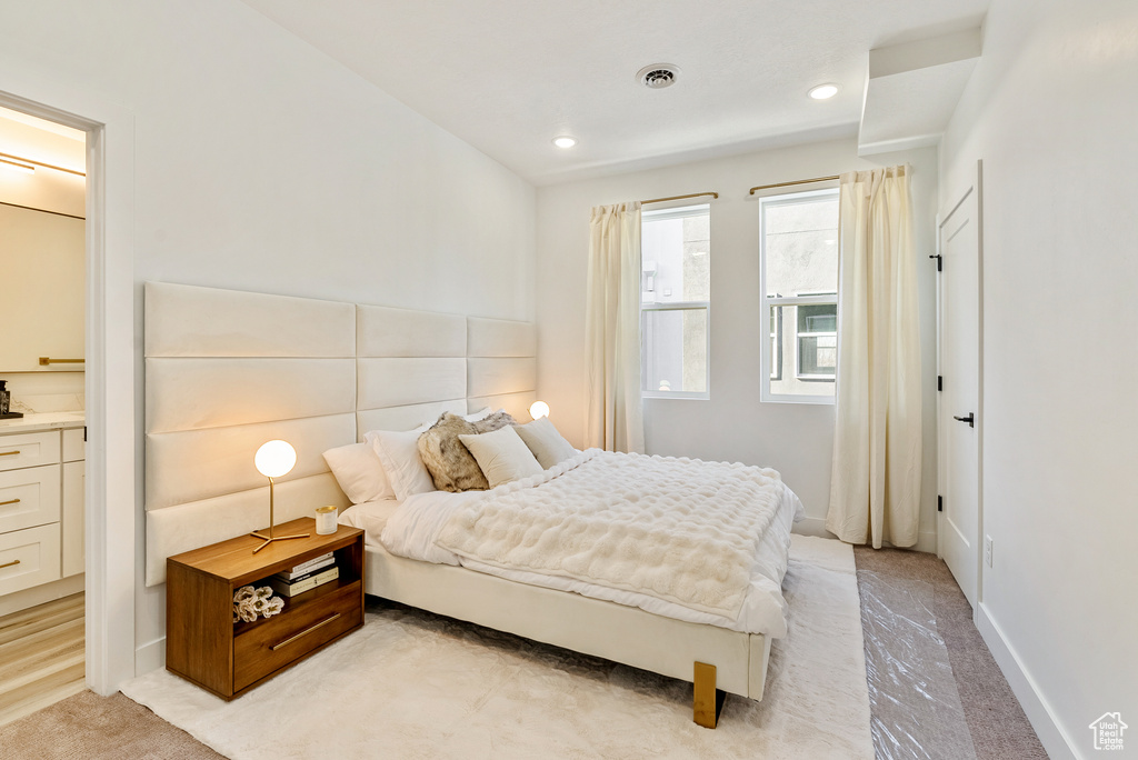 Bedroom featuring light carpet, visible vents, and recessed lighting