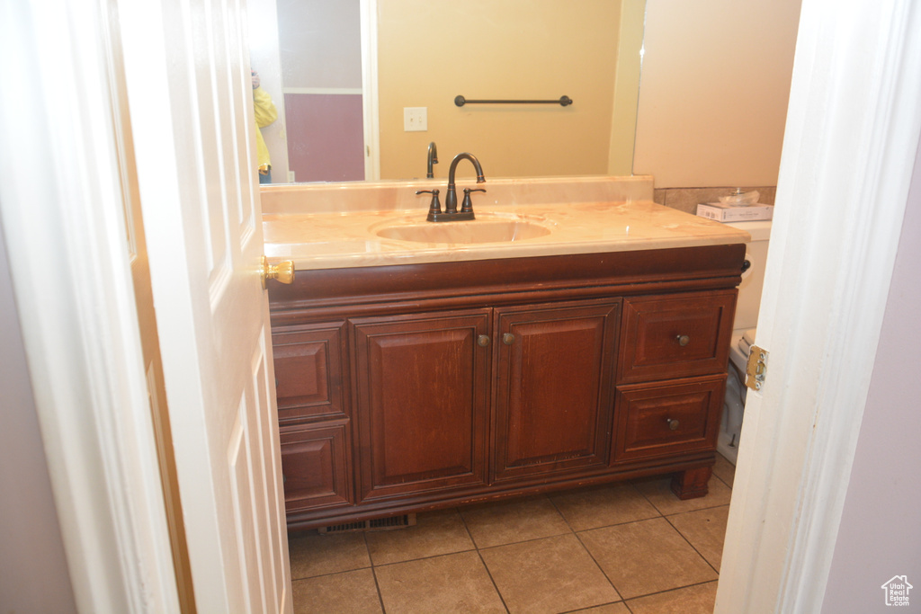 Bathroom with tile patterned flooring, visible vents, and vanity