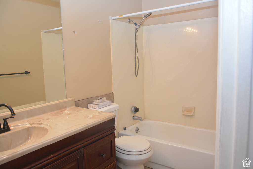 Bathroom featuring shower / bath combination, vanity, and toilet