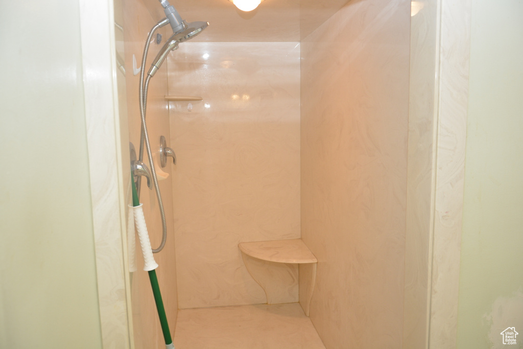 Bathroom with a marble finish shower