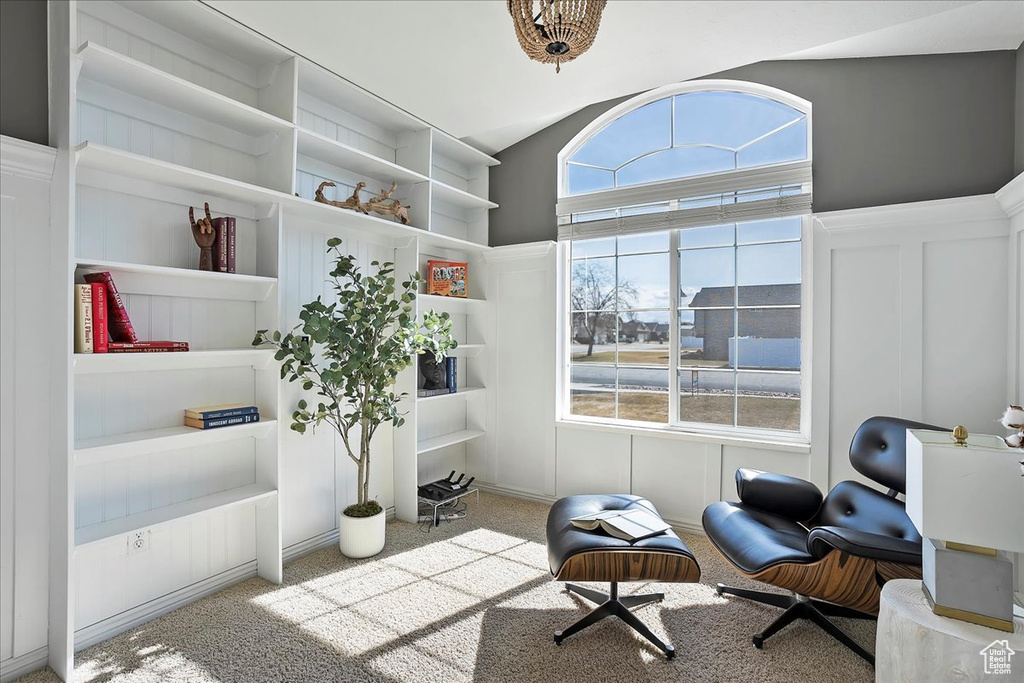 Sitting room with wainscoting, carpet, and a decorative wall