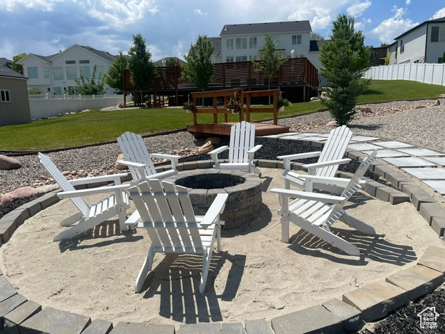 View of patio / terrace with an outdoor fire pit and a residential view