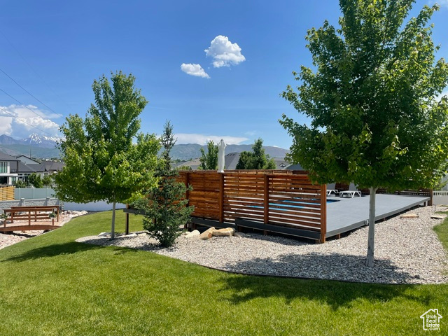 View of yard with a deck with mountain view