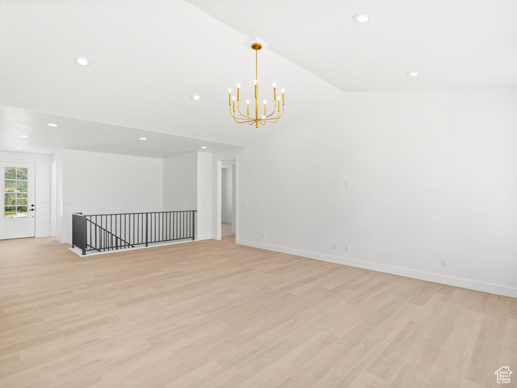 Empty room with recessed lighting, a chandelier, and light wood-style flooring
