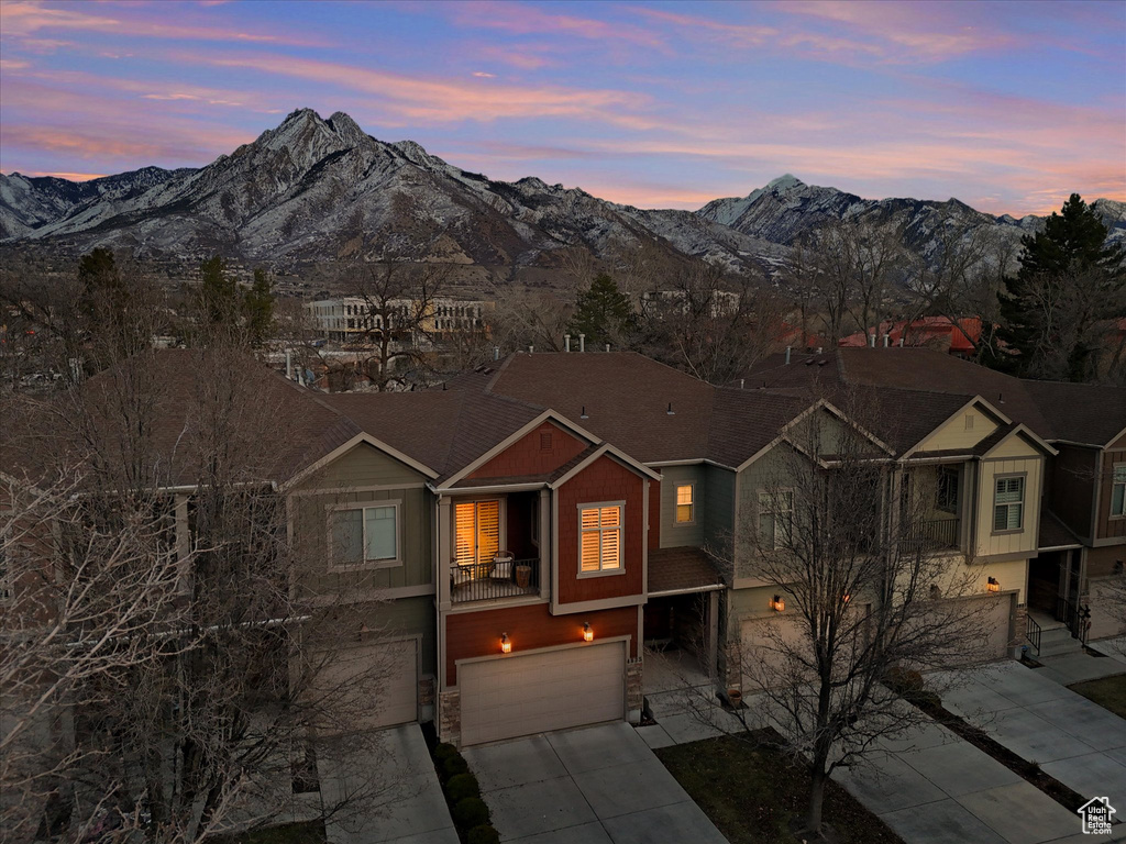 View of front of home featuring board and batten siding, a mountain view, driveway, and an attached garage