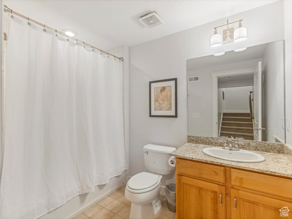 Bathroom with shower / bath combo, visible vents, toilet, and tile patterned floors