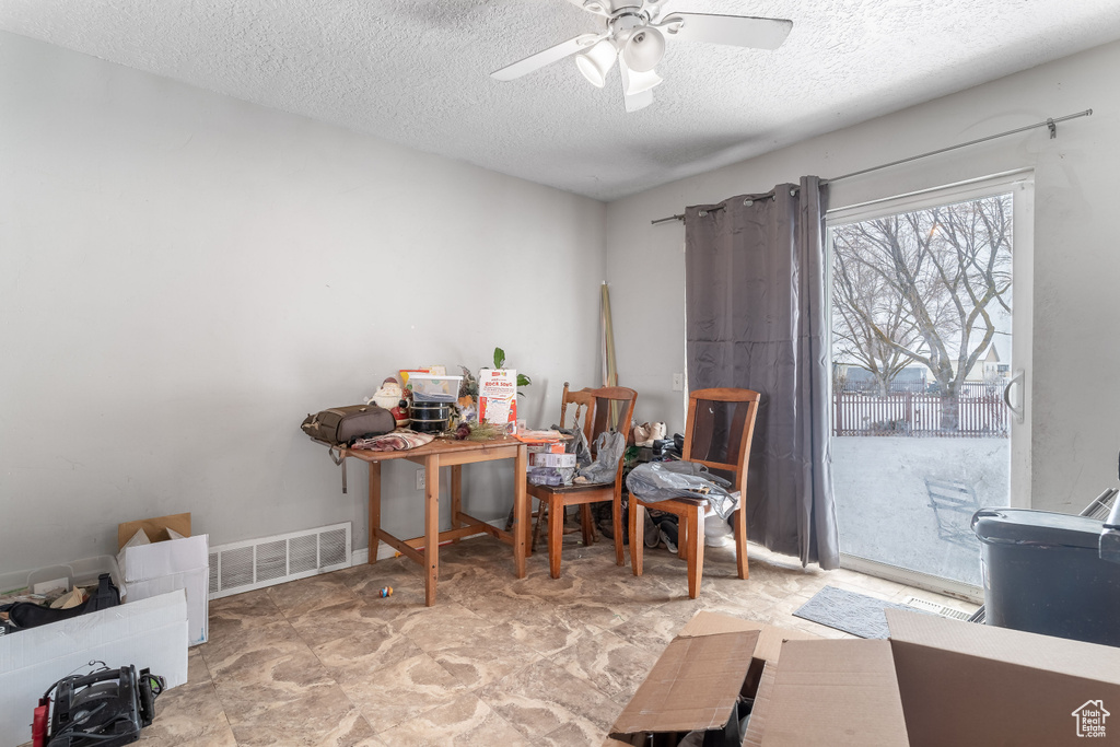 Interior space featuring visible vents, ceiling fan, and a textured ceiling