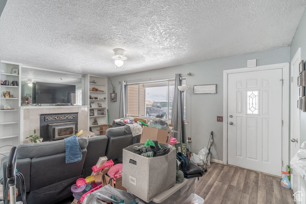 Living room featuring a textured ceiling and wood finished floors