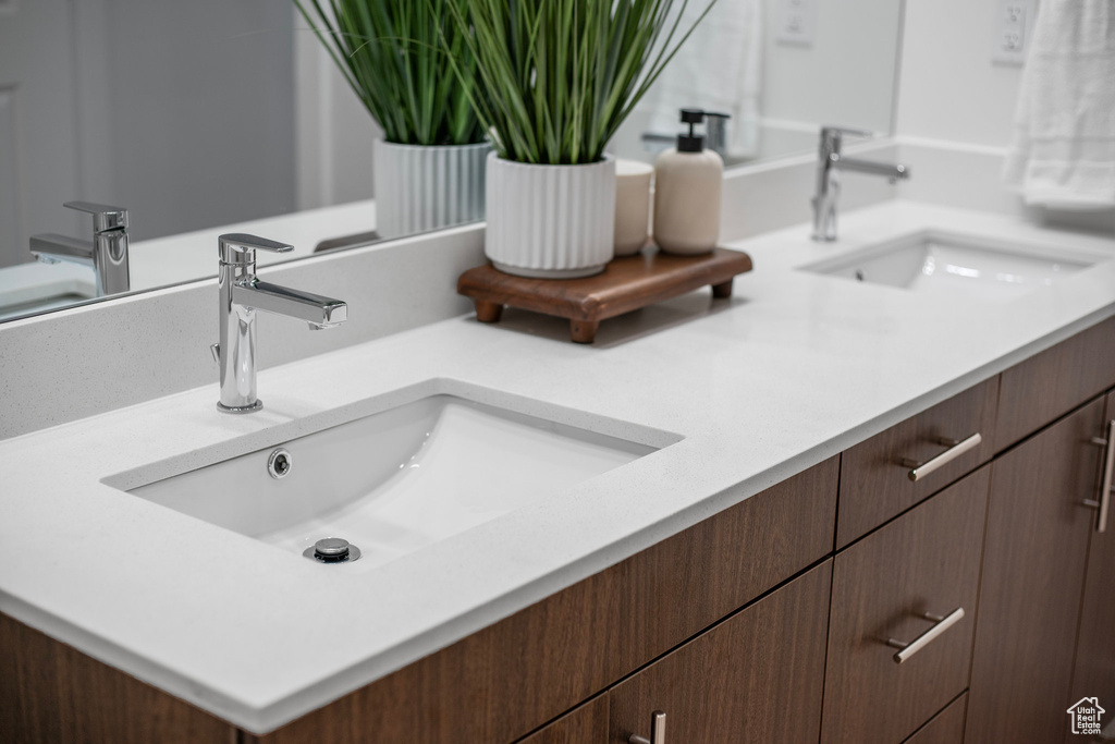 Bathroom featuring double vanity and a sink