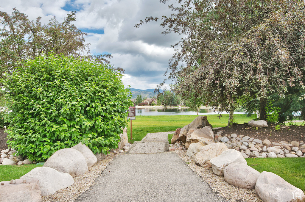 View of community with a yard and a water and mountain view