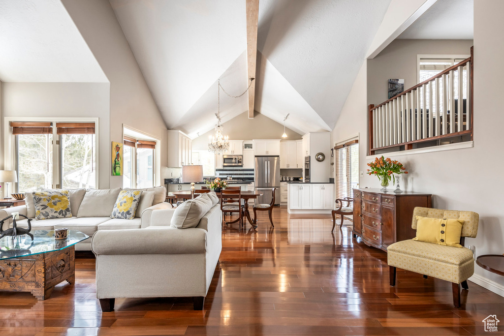 Living room with an inviting chandelier, dark wood finished floors, and a wealth of natural light