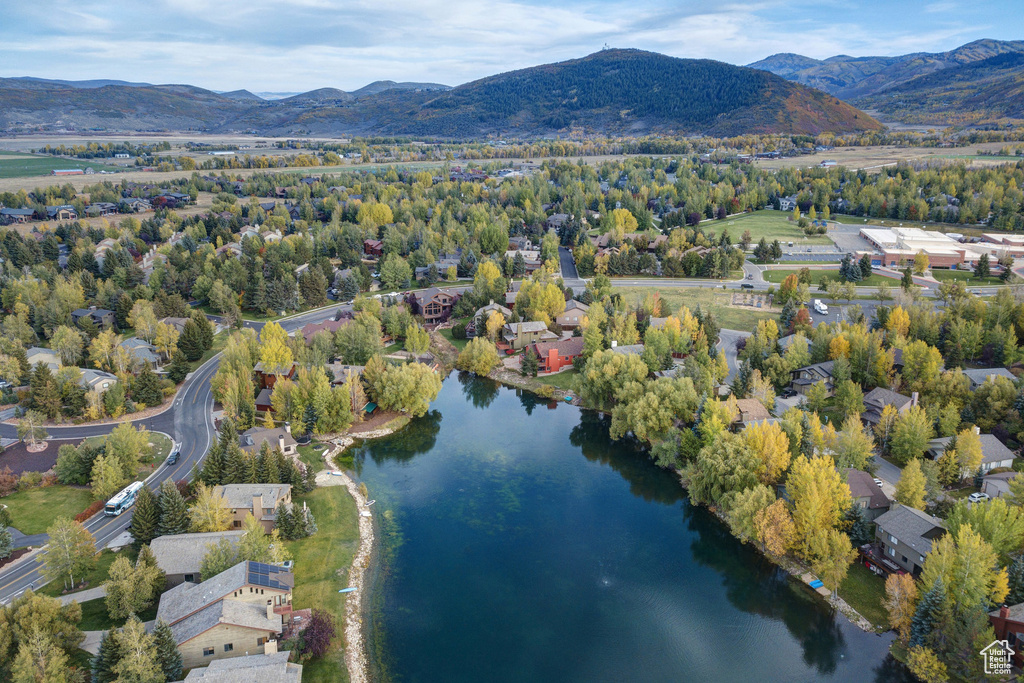 Drone / aerial view featuring a water and mountain view
