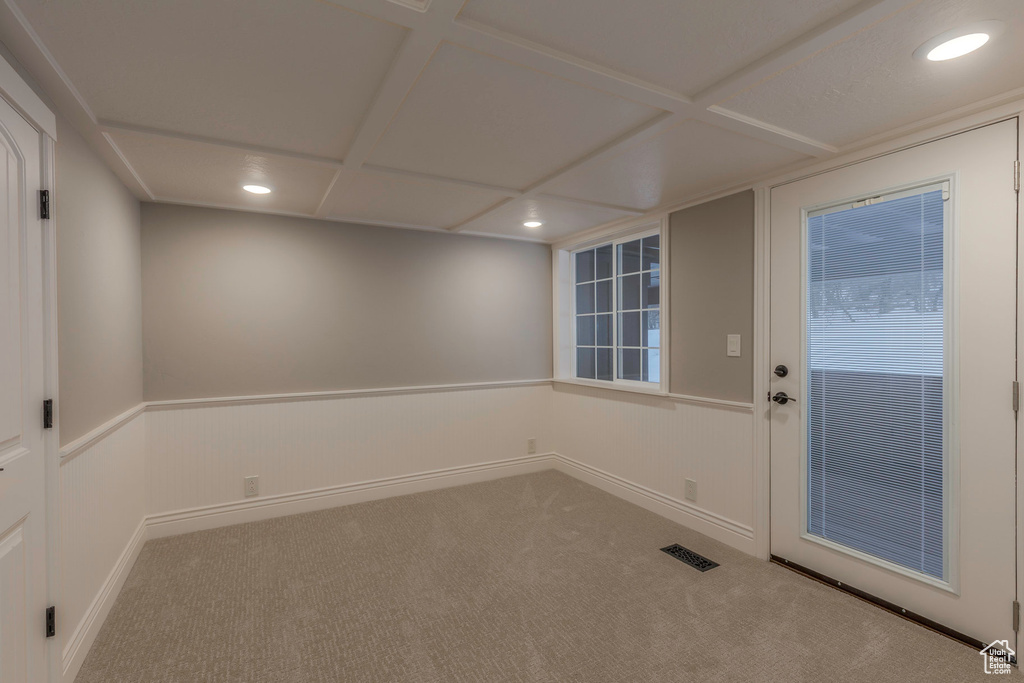 Empty room featuring carpet floors, recessed lighting, and visible vents