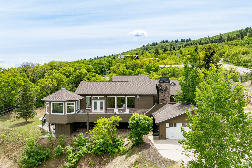 View from above of property featuring a heavily wooded area