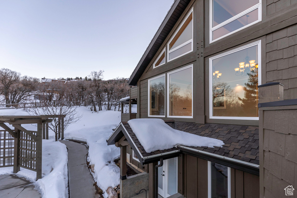 View of snowy exterior featuring a patio