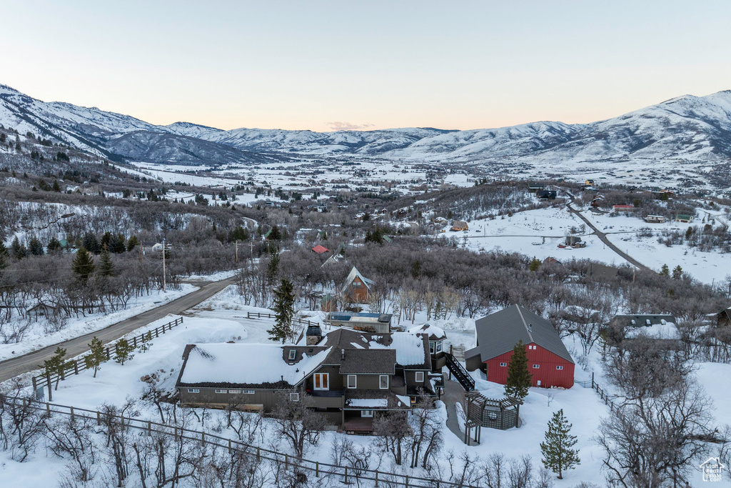 Snowy aerial view featuring a mountain view