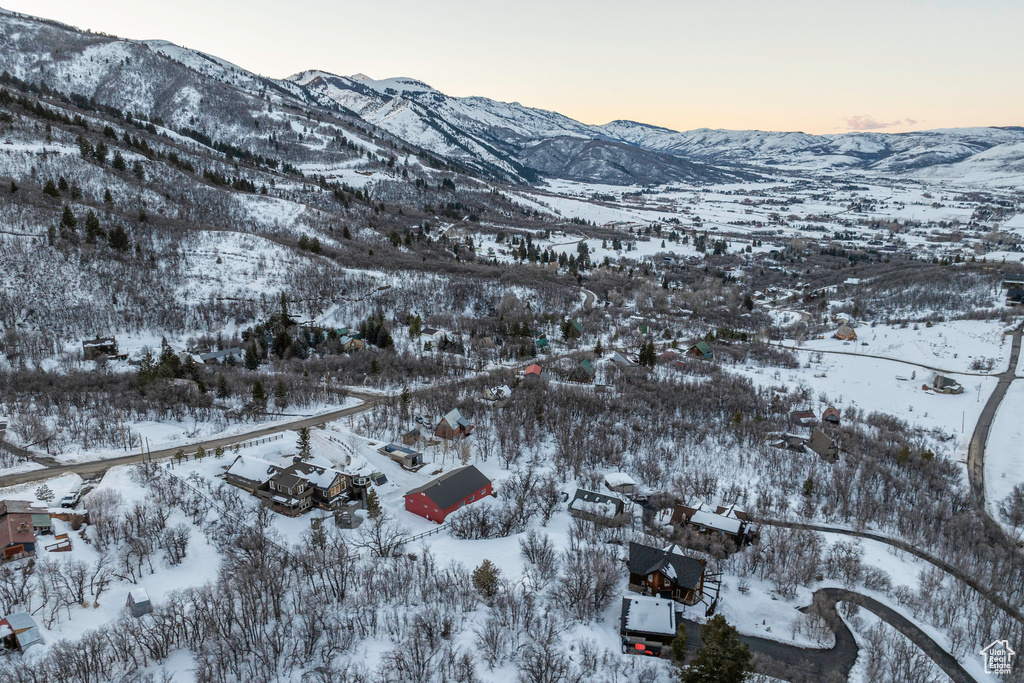 Snowy aerial view featuring a mountain view