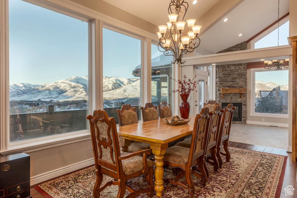 Dining room with recessed lighting, lofted ceiling, a mountain view, and a chandelier