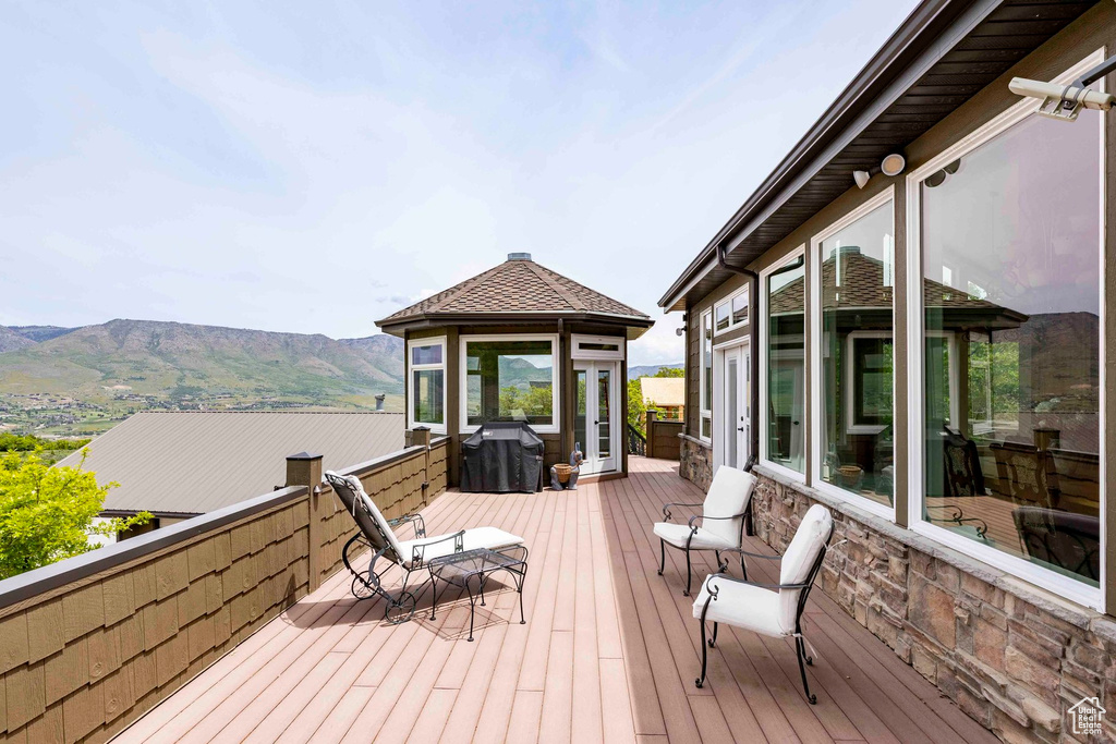 Deck with a mountain view and a gazebo