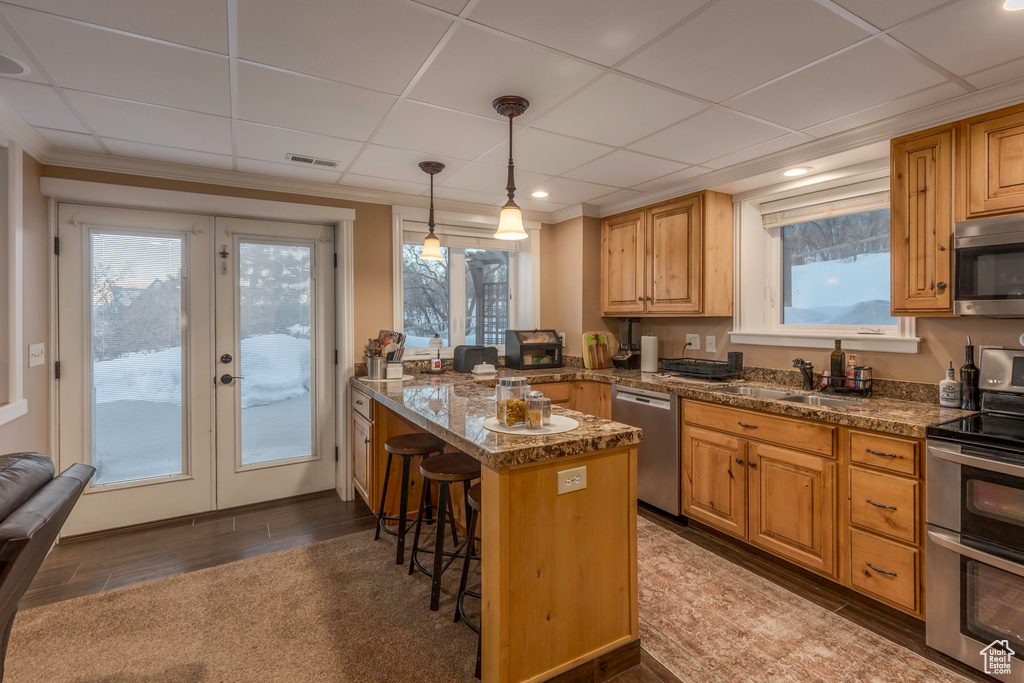 Kitchen featuring visible vents, a kitchen bar, french doors, a sink, and appliances with stainless steel finishes