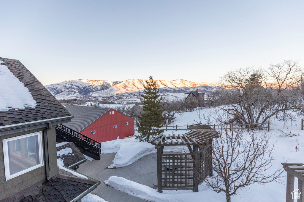 Snowy yard featuring stairs and a mountain view