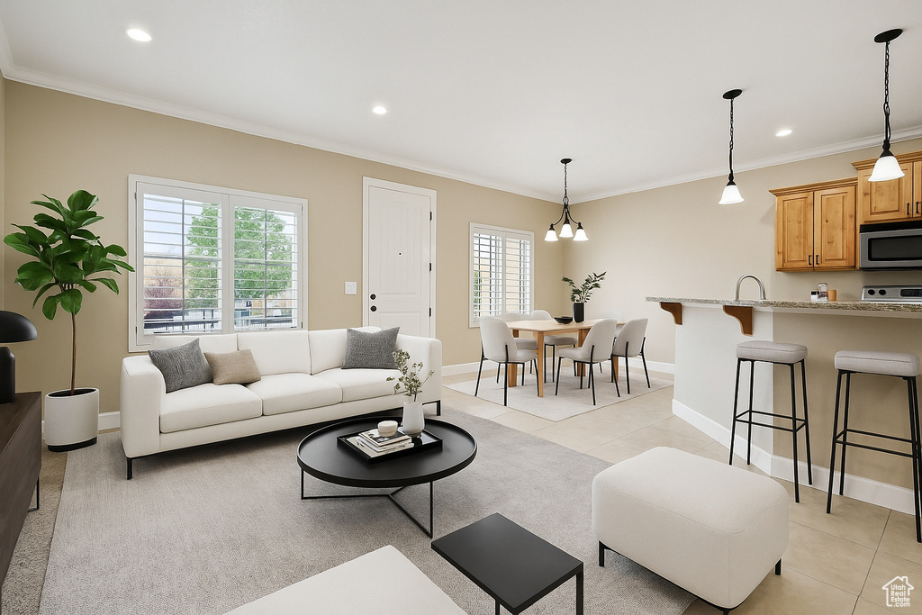 Living area featuring light tile patterned floors, healthy amount of natural light, baseboards, crown molding, and recessed lighting