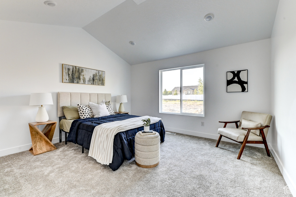 Bedroom featuring carpet floors, vaulted ceiling, and baseboards