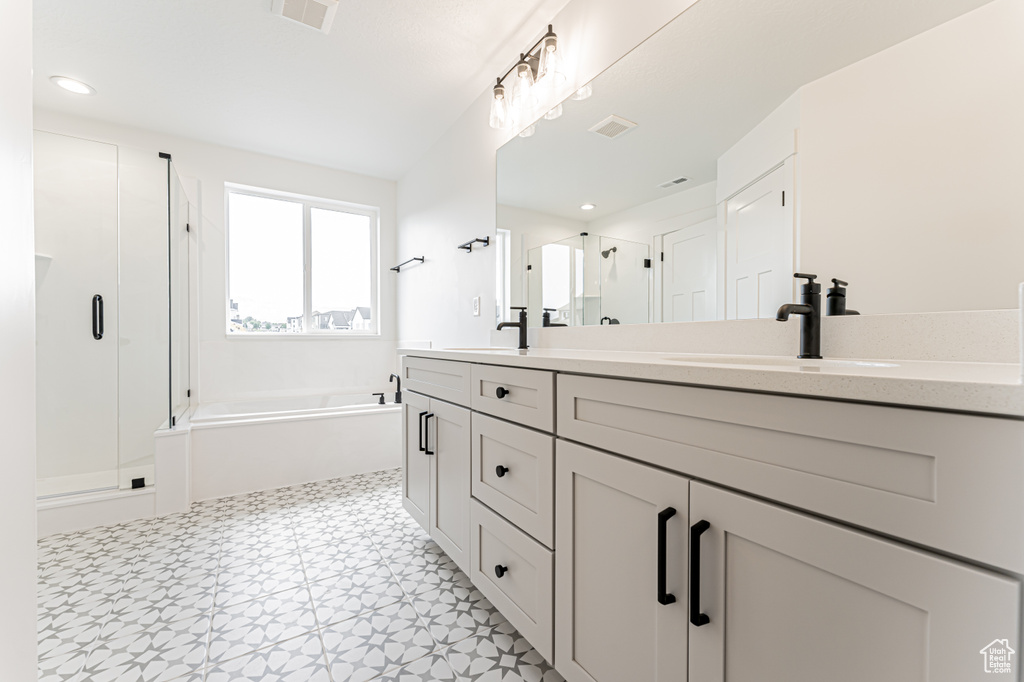 Full bathroom with a shower stall, double vanity, a garden tub, tile patterned floors, and recessed lighting