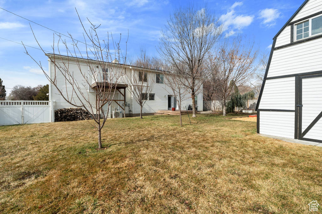 View of yard with fence and an outbuilding