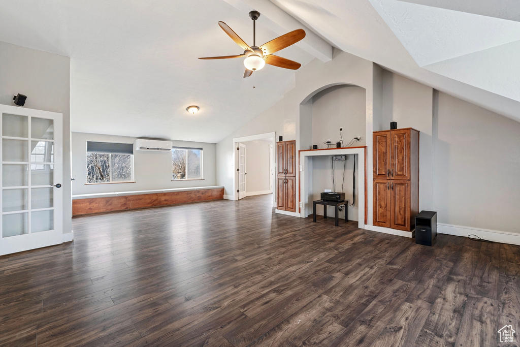 Unfurnished living room with dark wood-style floors, an AC wall unit, beamed ceiling, and ceiling fan