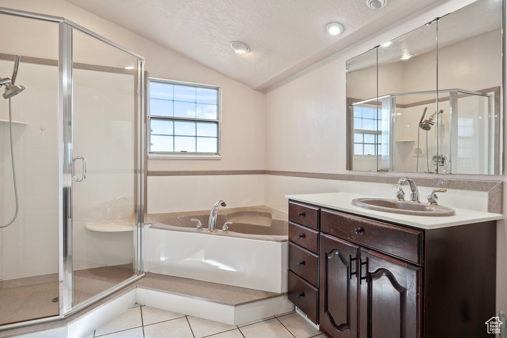 Bathroom featuring a stall shower, a healthy amount of sunlight, and tile patterned floors