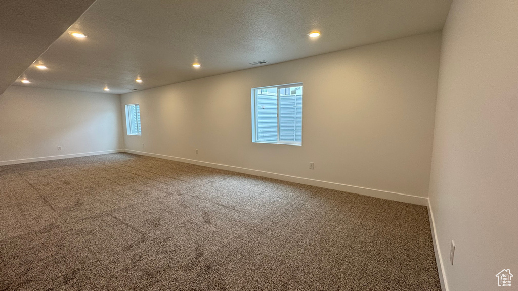 Spare room with baseboards, a textured ceiling, recessed lighting, and carpet floors