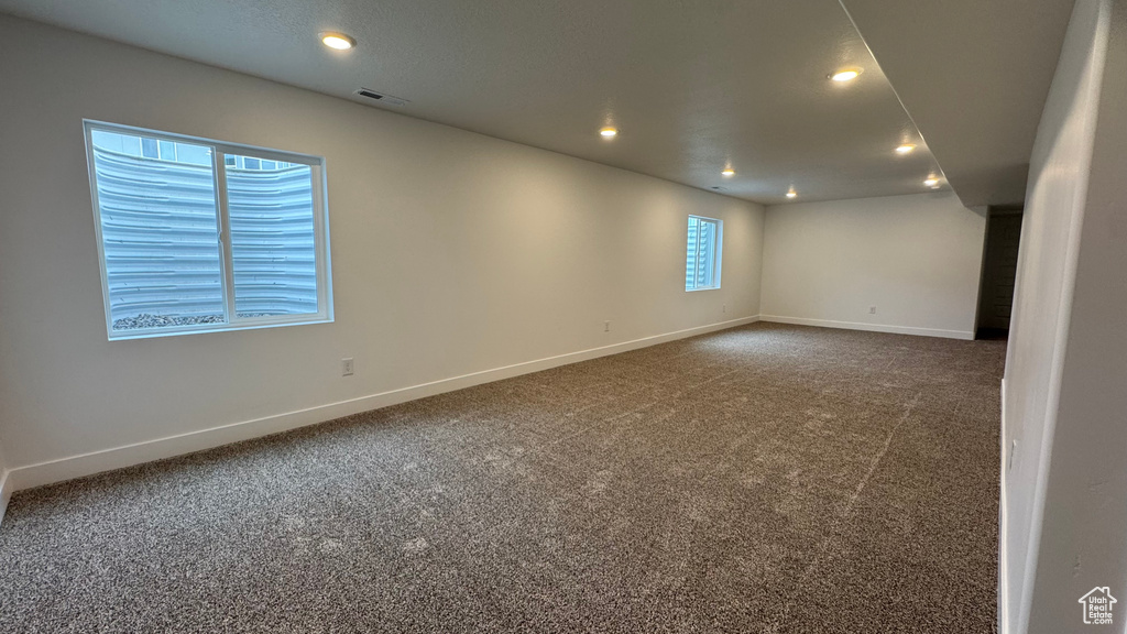 Spare room featuring baseboards, carpet flooring, and visible vents