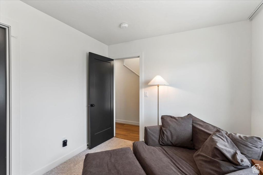 Living room featuring light colored carpet and baseboards