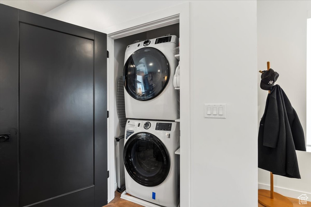 Washroom with laundry area and stacked washing maching and dryer