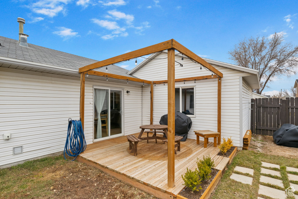 Wooden deck featuring fence and grilling area