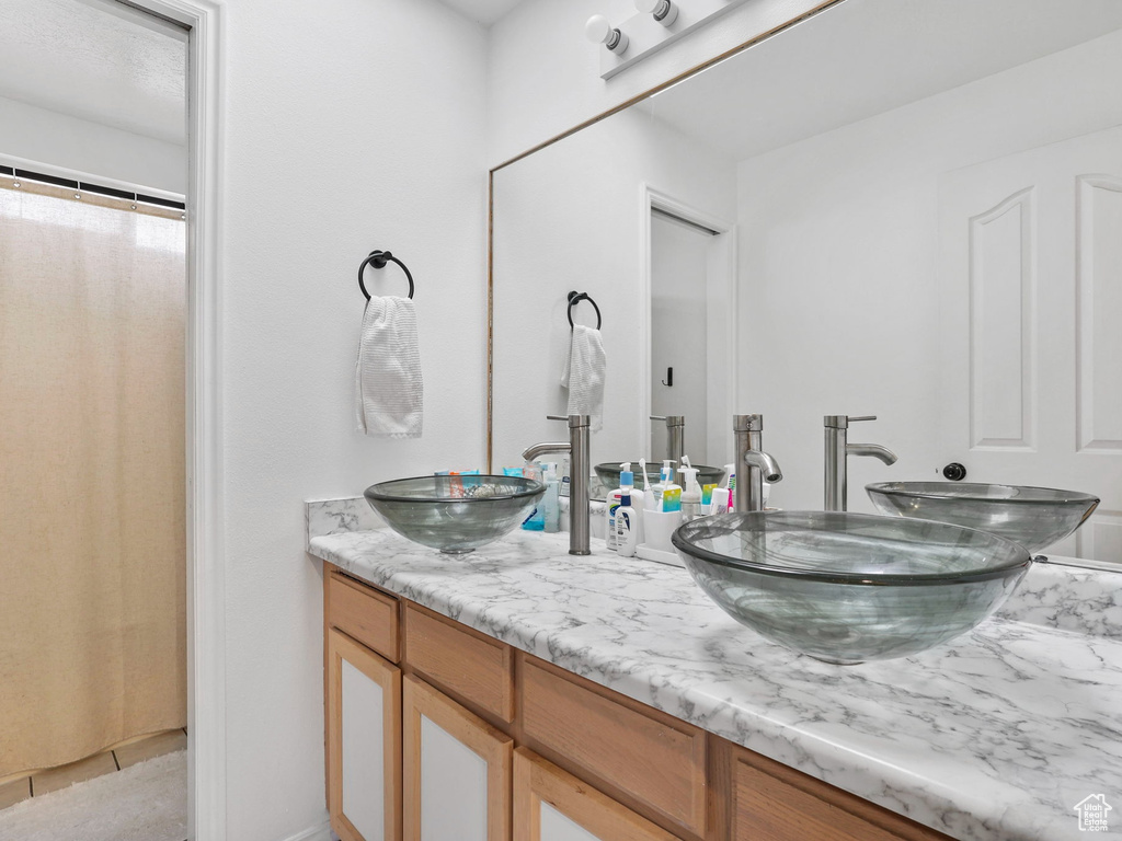 Full bath with double vanity and a sink