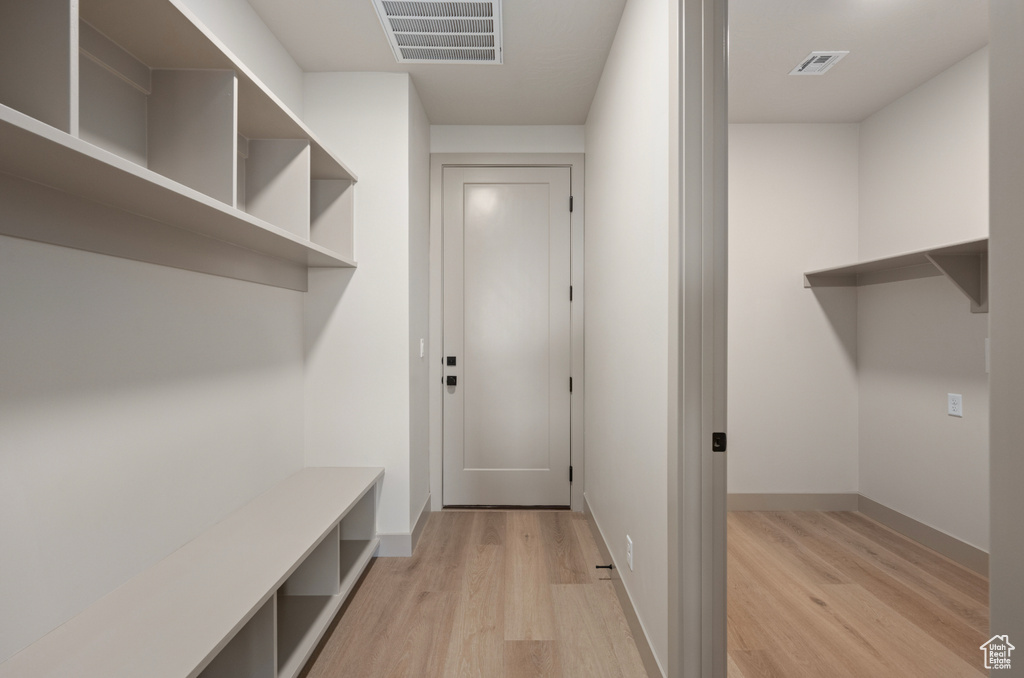Mudroom featuring baseboards, light wood-style floors, and visible vents