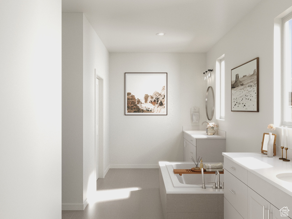 Bathroom featuring a tub to relax in, recessed lighting, baseboards, and vanity