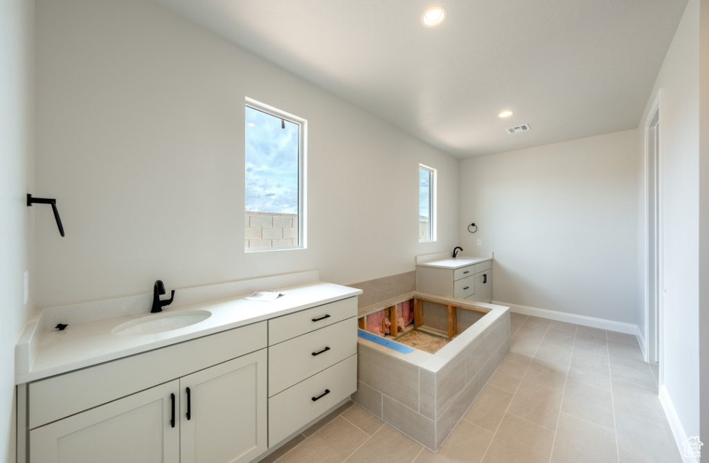 Bathroom with vanity, recessed lighting, tile patterned flooring, and baseboards