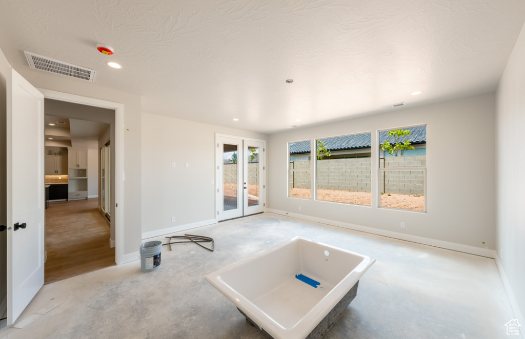 Unfurnished room with recessed lighting, french doors, and baseboards
